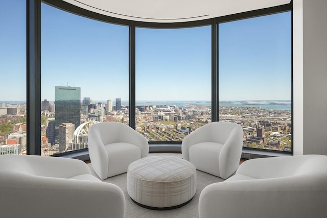 sitting room with a city view and expansive windows