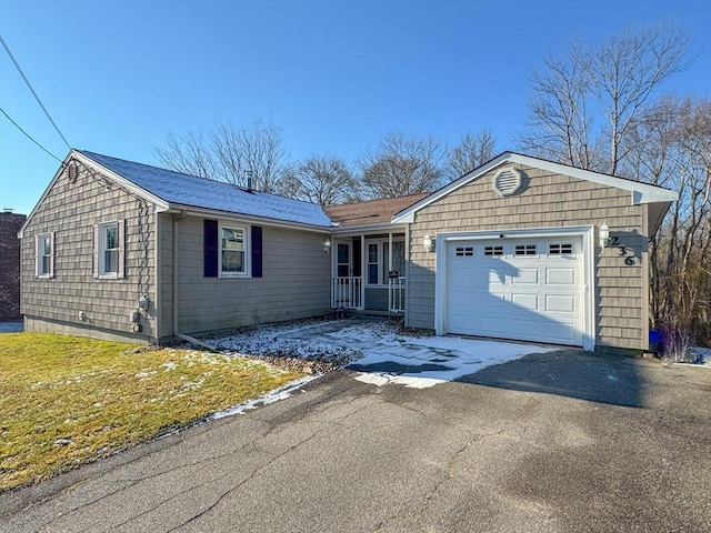 single story home featuring a front lawn and a garage