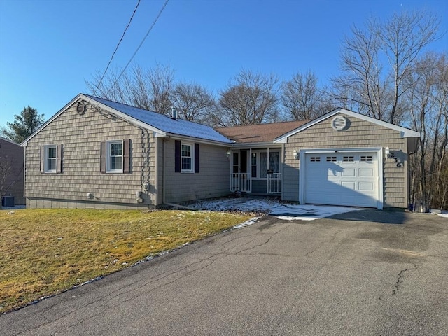 single story home featuring a garage and a front lawn