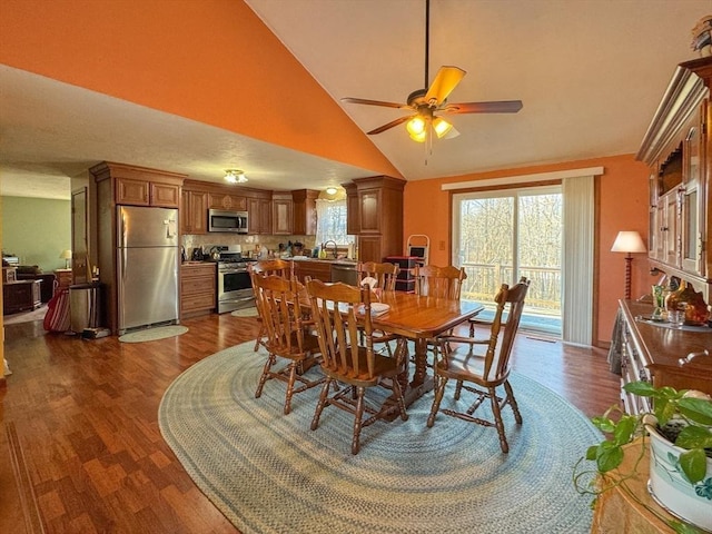 dining area featuring high vaulted ceiling, sink, dark hardwood / wood-style floors, and ceiling fan