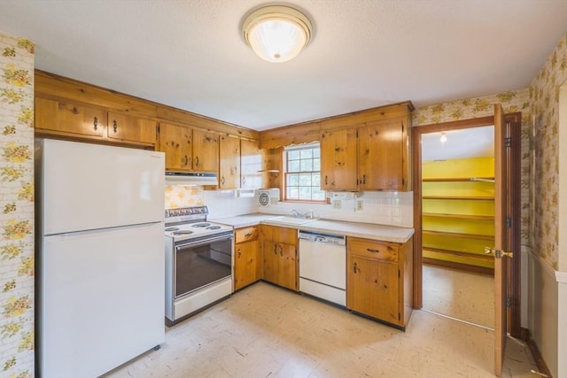 28 Marks Rd, Weymouth, MA 02189 - kitchen with white appliances, wallpapered walls, under cabinet range hood, a sink, and light countertops