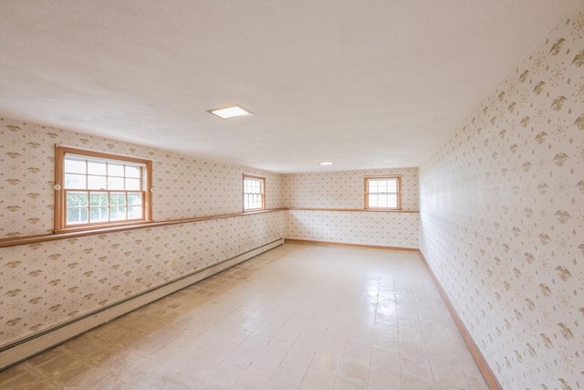 28 Marks Rd, Weymouth, MA 02189 - empty room featuring wallpapered walls, plenty of natural light, a baseboard heating unit, and baseboards