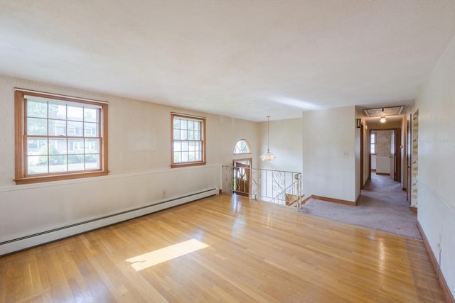 28 Marks Rd, Weymouth, MA 02189 - empty room with a baseboard heating unit, wood finished floors, attic access, and baseboards