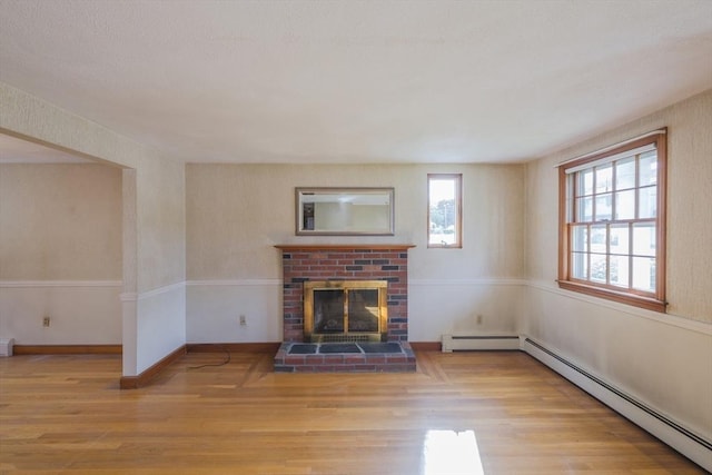 28 Marks Rd, Weymouth, MA 02189 - unfurnished living room with wood finished floors, a baseboard heating unit, and a fireplace