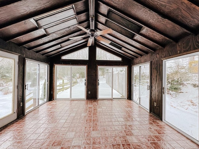 unfurnished sunroom featuring ceiling fan and lofted ceiling with beams