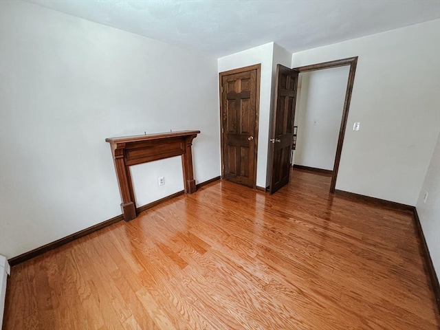 empty room with light wood finished floors and baseboards