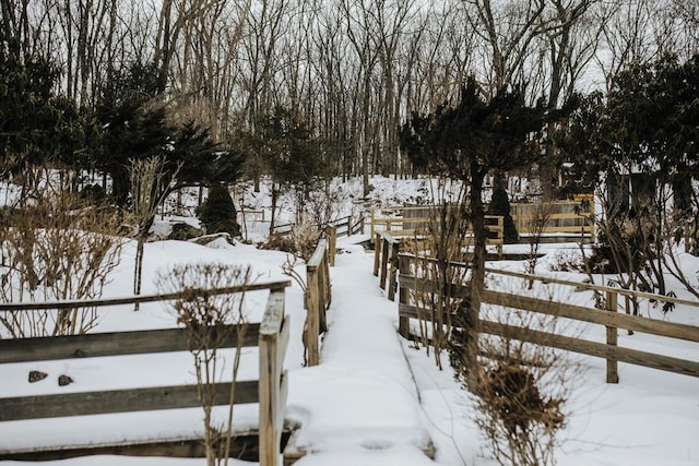 yard covered in snow featuring fence