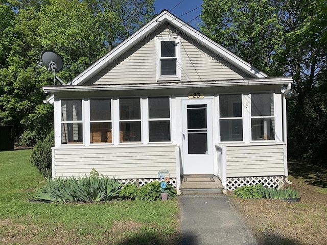 23 A St, North Adams, MA 01220 - bungalow-style house with a sunroom, a front yard, and entry steps