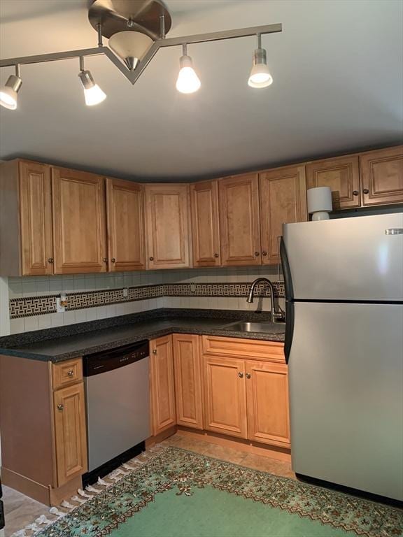 23 A St, North Adams, MA 01220 - kitchen featuring appliances with stainless steel finishes, dark countertops, backsplash, and brown cabinetry