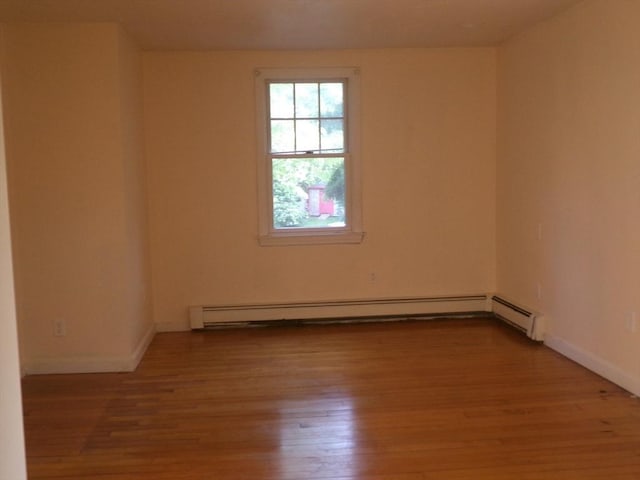 19 Saint Anns Ln, Falmouth, MA 02536 - empty room with a baseboard heating unit and light wood-style flooring