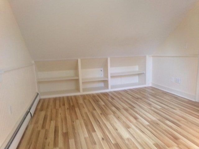 19 Saint Anns Ln, Falmouth, MA 02536 - additional living space featuring a baseboard heating unit, light wood-style flooring, built in features, wainscoting, and vaulted ceiling