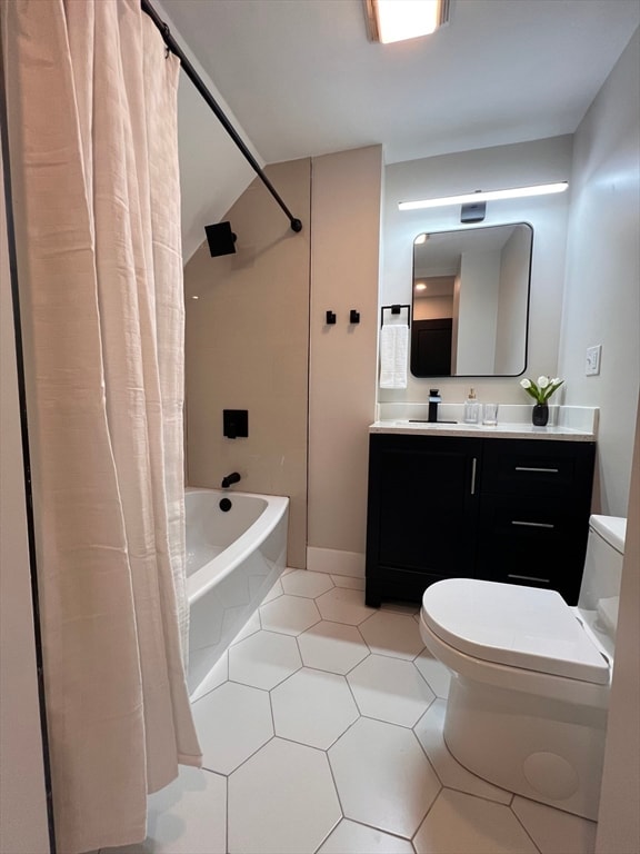 full bathroom with vanity, toilet, tile patterned floors, and shower / bath combo with shower curtain