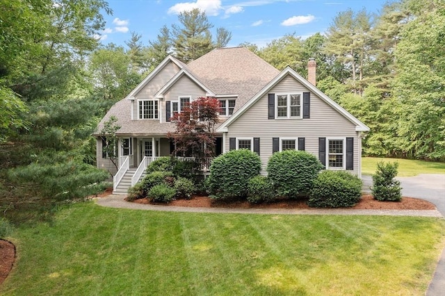 5 Mckinley Dr, Acton, MA 01720 - traditional-style home with covered porch, a front lawn, a chimney, stairway, and roof with shingles