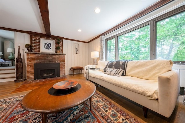 32 Fern St, Concord, MA 01742 - living room featuring wood finished floors, a brick fireplace, crown molding, and beam ceiling