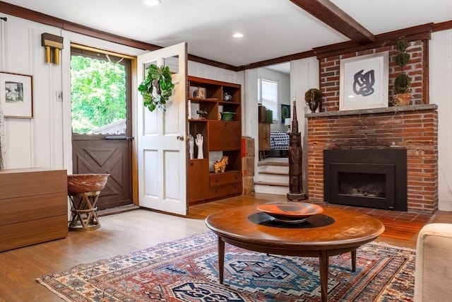 32 Fern St, Concord, MA 01742 - living area featuring wood finished floors, a fireplace, plenty of natural light, and beam ceiling