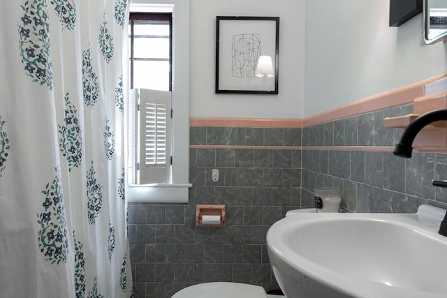 32 Fern St, Concord, MA 01742 - bathroom with a sink, tile walls, toilet, and a shower with shower curtain