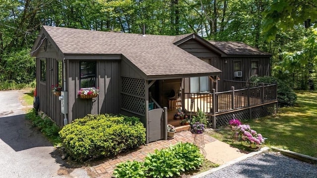 32 Fern St, Concord, MA 01742 - view of front of property with roof with shingles and a wooden deck