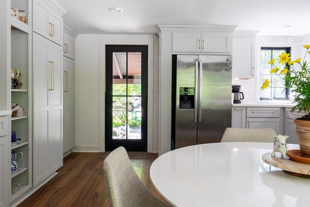 32 Fern St, Concord, MA 01742 - kitchen featuring stainless steel fridge with ice dispenser, light countertops, dark wood-type flooring, and white cabinetry