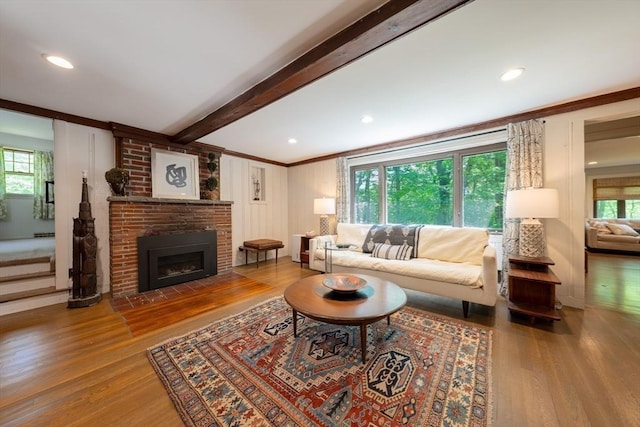 32 Fern St, Concord, MA 01742 - living area with wood finished floors, beamed ceiling, a fireplace, and ornamental molding