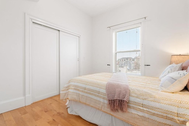 bedroom featuring a closet and wood finished floors