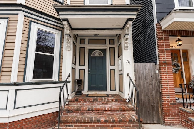 doorway to property featuring fence