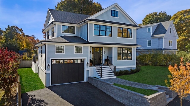 view of front facade with a garage and a front lawn