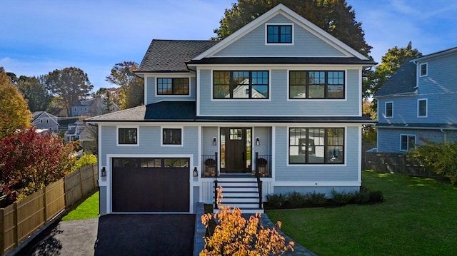 view of front of property with a garage and a front lawn