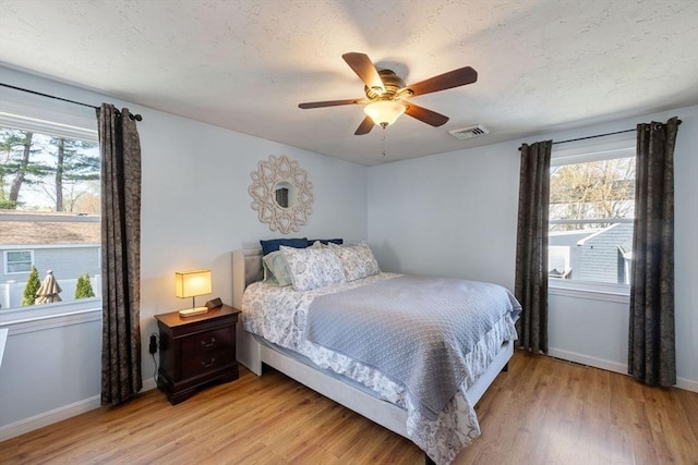 69 W Shore Rd, Holbrook, MA 02343 - bedroom with light wood finished floors, multiple windows, and baseboards