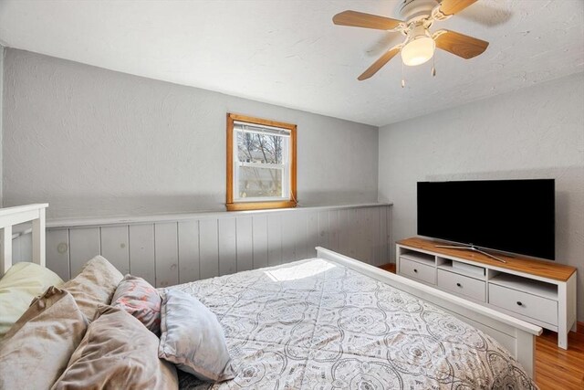 69 W Shore Rd, Holbrook, MA 02343 - bedroom with wood finished floors, wainscoting, and a ceiling fan