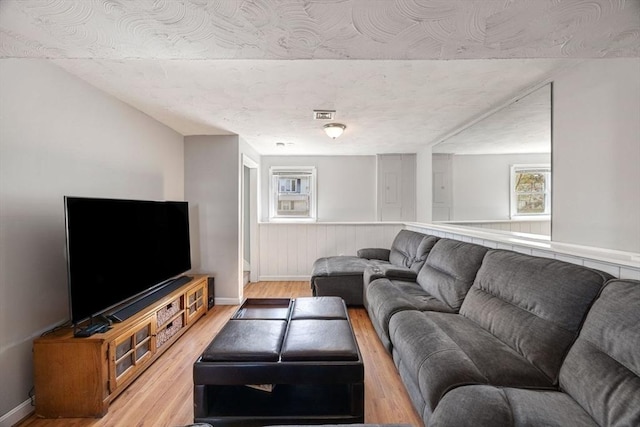 69 W Shore Rd, Holbrook, MA 02343 - living room featuring light wood-type flooring, healthy amount of natural light, and baseboards
