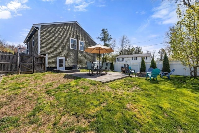 69 W Shore Rd, Holbrook, MA 02343 - back of house featuring a fire pit, a patio, and a gate