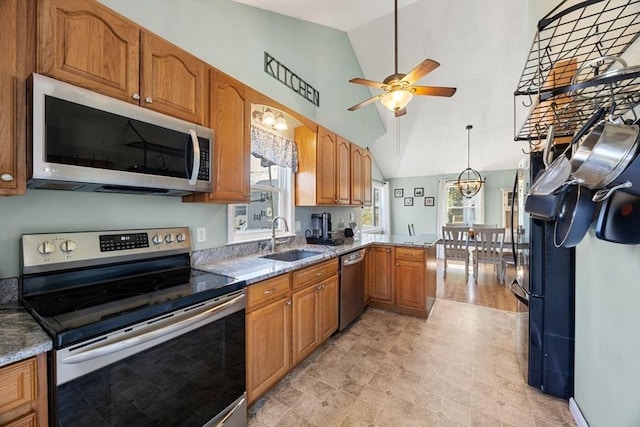 69 W Shore Rd, Holbrook, MA 02343 - kitchen with appliances with stainless steel finishes, a sink, vaulted ceiling, a ceiling fan, and a peninsula