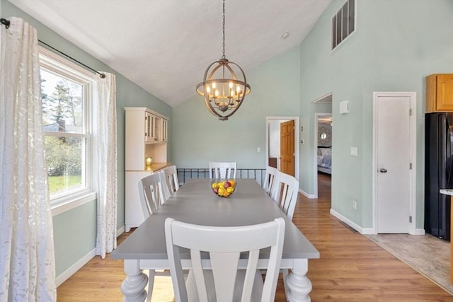 69 W Shore Rd, Holbrook, MA 02343 - dining area with a chandelier, vaulted ceiling, light wood finished floors, and baseboards