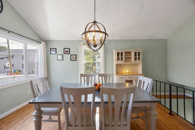 69 W Shore Rd, Holbrook, MA 02343 - dining space with light wood-type flooring, a chandelier, baseboards, and lofted ceiling