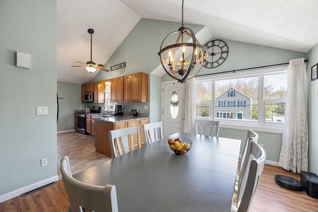 69 W Shore Rd, Holbrook, MA 02343 - dining space featuring a chandelier, baseboards, ceiling fan, wood finished floors, and high vaulted ceiling