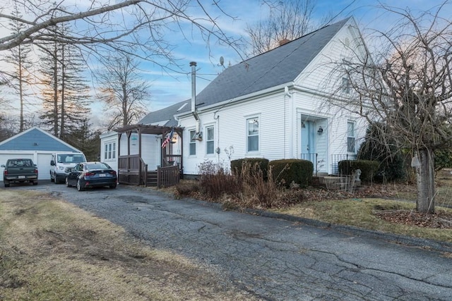 view of front of property with a garage and an outbuilding