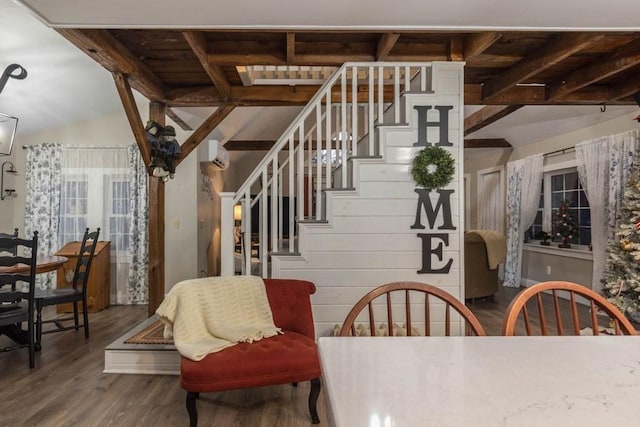 dining area featuring a wall mounted air conditioner, hardwood / wood-style floors, wooden walls, and lofted ceiling