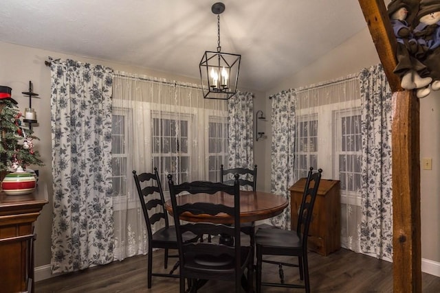 dining space featuring vaulted ceiling, a chandelier, and dark hardwood / wood-style floors