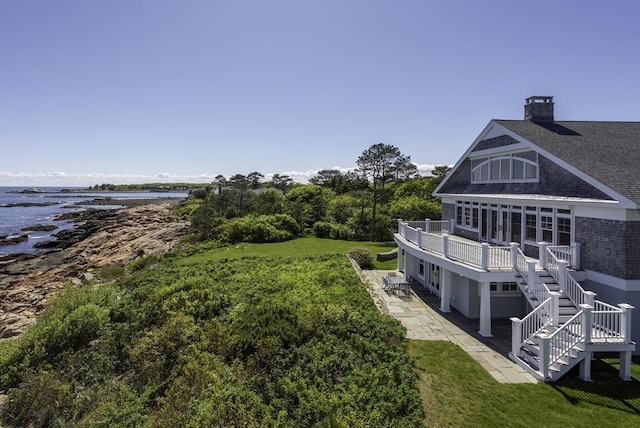 240 Atlantic Rd, Gloucester, MA 01930 - view of green lawn with a patio area, stairway, and a deck with water view