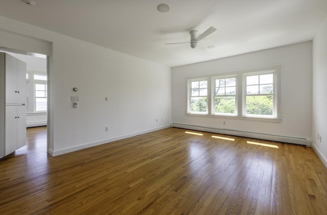240 Atlantic Rd, Gloucester, MA 01930 - empty room featuring baseboard heating, plenty of natural light, a ceiling fan, and wood finished floors