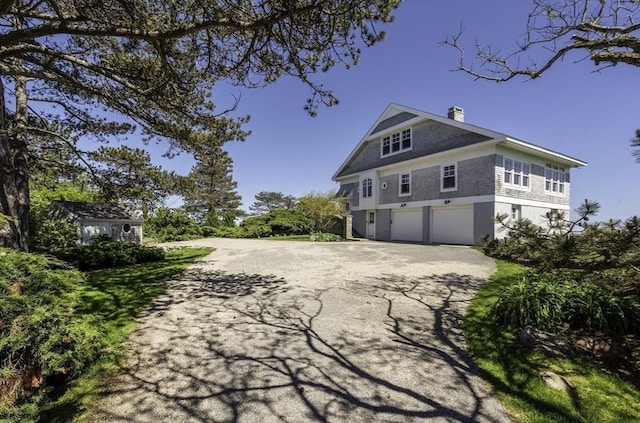 240 Atlantic Rd, Gloucester, MA 01930 - view of side of home featuring driveway, a garage, and a chimney