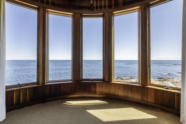 240 Atlantic Rd, Gloucester, MA 01930 - unfurnished sunroom with a water view, carpet, and wood walls