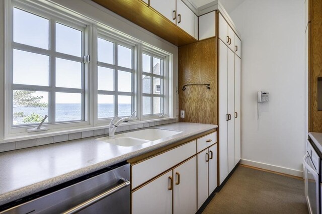 240 Atlantic Rd, Gloucester, MA 01930 - kitchen with stainless steel appliances, a sink, a water view, white cabinetry, and baseboards