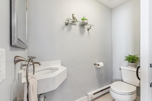 bathroom featuring a baseboard radiator and toilet