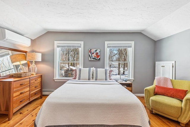 bedroom with a baseboard heating unit, lofted ceiling, an AC wall unit, and light wood-style flooring