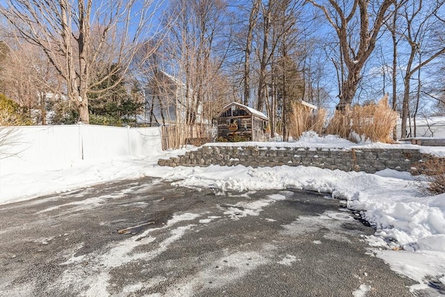 yard layered in snow with fence