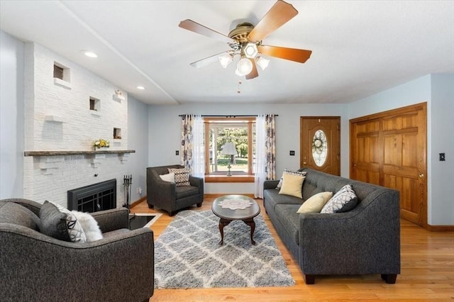 472 Potter Rd, Framingham, MA 01701 - living area with light wood finished floors, a ceiling fan, a fireplace, and recessed lighting