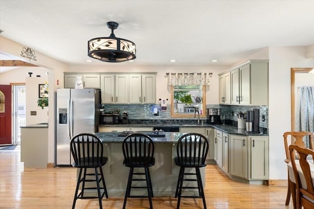 472 Potter Rd, Framingham, MA 01701 - kitchen with black appliances, backsplash, a center island, light wood-style flooring, and recessed lighting