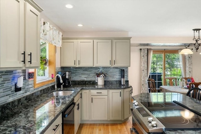 472 Potter Rd, Framingham, MA 01701 - kitchen with black dishwasher, light wood-style floors, tasteful backsplash, hanging light fixtures, and recessed lighting