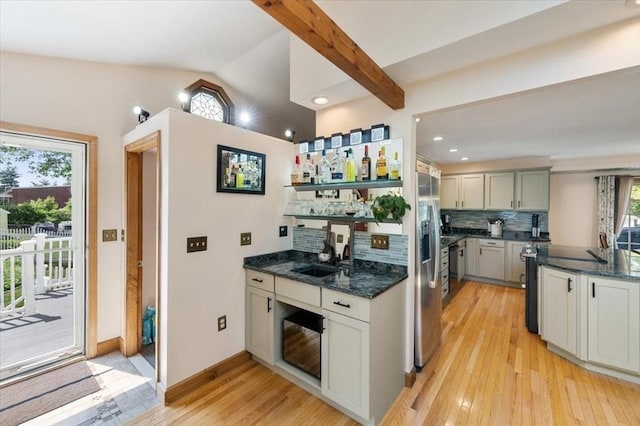 472 Potter Rd, Framingham, MA 01701 - kitchen featuring decorative backsplash, light wood-type flooring, vaulted ceiling, dark stone countertops, and recessed lighting